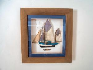 a picture of a boat in a frame on a wall at Knocker Cottage is a 3 bedroom made up of 1 double bedroom and 2 small double bedrooms in small village 10 min to beaches in Camborne