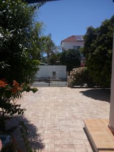 a stone patio with a fence in a yard at Summer Breeze - Cheerful 2 bedroom villa with pool in Ayia Napa