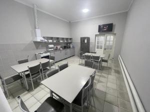 a room with tables and chairs in a kitchen at RD-HOSTEL in Tashkent