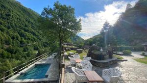 a view of a pool with chairs and a table at Agriturismo Alberobello in Viganella