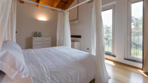 a bedroom with a white bed and a window at VILLA KIMIA 8, Emma Villas in Acireale +36 photos