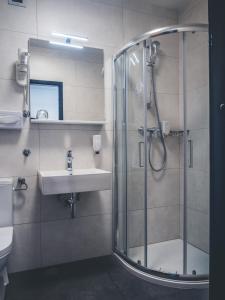 a bathroom with a shower and a sink at Sabotin, Hotel & Restaurant in Nova Gorica