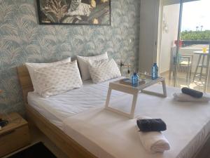 a bedroom with a bed with a table on it at lovely and chic Appartment in asilah marina golf in Asilah
