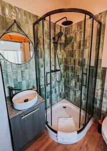a bathroom with a shower with a sink and a toilet at Charming Old Town Retreat in Klaipėda
