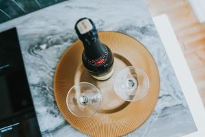 a bottle of beer and two glasses on a table at Charming Old Town Retreat in Klaipėda