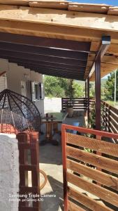a patio with a wooden pergola and a table at Zante Sunny Mountain in Anafonítria