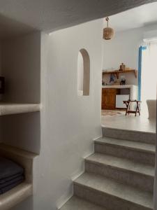 a staircase leading to a living room and a kitchen at BLUE IN NAXOS in Naxos Chora