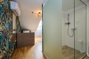 a bathroom with a shower and a glass door at ROOMS in Szombathely