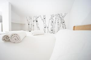 a bedroom with two beds with white sheets at Smiley 2 in Novalja