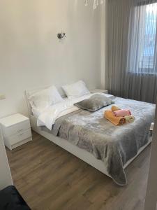 a bedroom with a bed with a stuffed animal on it at Apartment in centre of Yerevan in Yerevan