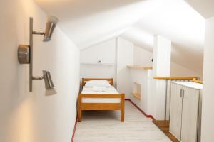 a small bedroom with a bed in a attic at Smiley 2 in Novalja