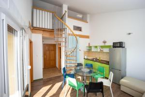 a kitchen and dining room with a spiral staircase in a apartment at Smiley 2 in Novalja