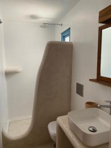 a bathroom with a sink and a toilet at BLUE IN NAXOS in Naxos Chora