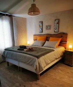 a bedroom with a large bed and two lamps at chambres d hotes Ysalice in Merlas