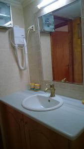 a bathroom sink with a mirror and a hair dryer at Sipsas Villas in Koroni