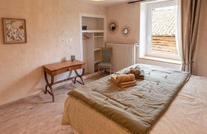 a bedroom with a bed and a desk and a window at Ysalice in Merlas