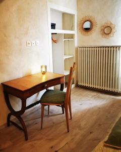 a table and a chair in a room at chambres d hotes Ysalice in Merlas