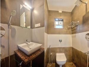 a bathroom with a sink and a toilet at Amazing 2BHK Apartment Near Baga Beach By Stay Over Home in Baga