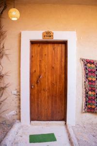a wooden door with a no entry sign on it at Aghurmi Siwa Ecolodge & Salt Cave in Siwa