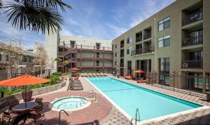 a swimming pool in front of a building at San Jose 2BR w Gym WD Pool nr Caltrain SFO-921 in San Jose