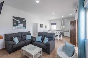 a living room with a couch and a table at Casa Rural María Lantejuela in La Lantejuela