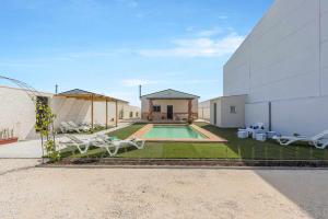 a house with a swimming pool next to a building at Casa Rural María Lantejuela in La Lantejuela