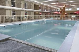 a large swimming pool in a large building at Ramada by Wyndham Sterling in Sterling