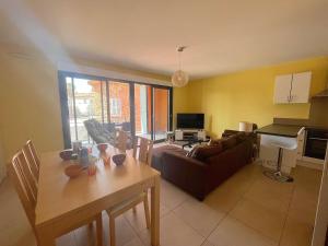 a living room with a couch and a table in it at Appartement Fréjus, 3 pièces, 4 personnes - FR-1-226A-290 in Fréjus