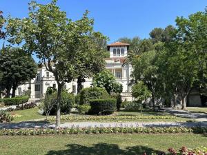 a large white house with a garden in front of it at Appartement Fréjus, 3 pièces, 4 personnes - FR-1-226A-290 in Fréjus