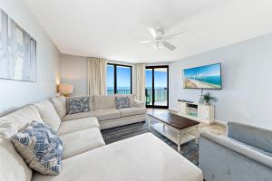 a living room with a couch and a ceiling fan at Phoenix X 907 in Orange Beach