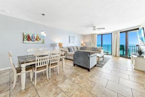 a living room with a table and a couch at Phoenix X 907 in Orange Beach