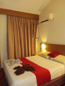 two beds in a hotel room with towels on them at Sea Breeze Village, Baga Goa in Calangute