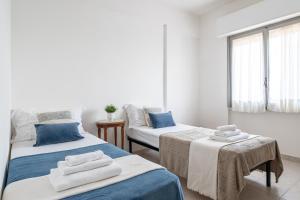 a room with two beds with towels on them at Lungomare 90 - YourPlace Abruzzo in Fossacesia