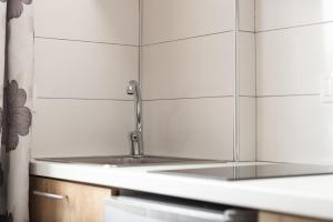 a kitchen with a sink with a faucet at Eolica Rooms in Sarti +62 photos