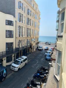 a city street with cars and motorcycles parked next to buildings at Seaside Hotel in Brighton & Hove