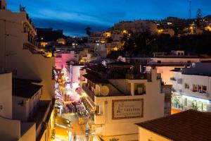 a view of a city at night at Hotel Baltum in Albufeira