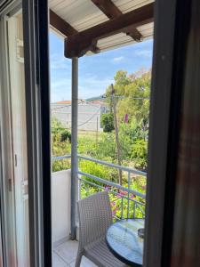 a view from a balcony with a table and chair at Gardenia studios in Nydri