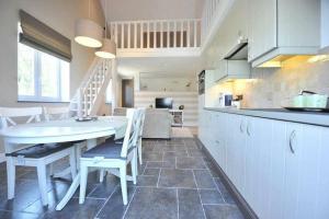 a kitchen with a table and chairs in a kitchen at Villa71 in Rijkevorsel