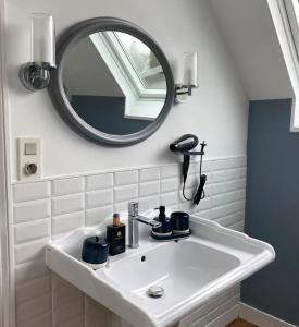 lavabo con espejo y secador de pelo en La Côte, en Granville