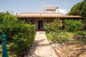 a house with a walkway in front of it at Baccu Mandara Sea View Modern Villa with Parking! in Geremeas