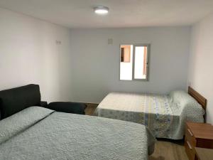 Posteľ alebo postele v izbe v ubytovaní CASA VACACIONAL CONIL
