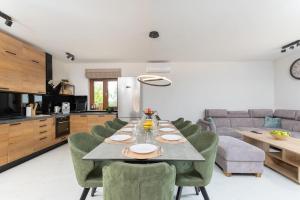 a dining room and kitchen with a table and chairs at Villa Dani by IstriaLux in Rovinjsko Selo