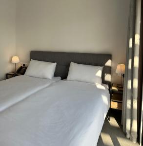 a bedroom with a large white bed with two pillows at Zoi Ayia Napa in Ayia Napa