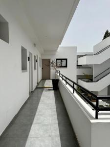a hallway of a building with white walls and stairs at Zoi Ayia Napa in Ayia Napa