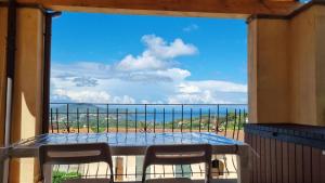 a balcony with a table and chairs and a view of the ocean at Appartamento Blu Relax in Capoliveri
