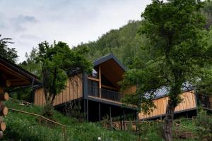 a house in the woods with trees at Qazaq Auyl Eco Hotel in Almaty
