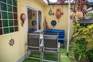 two chairs are sitting outside of a house at Ferienwohnung-fuer-4-Personen-in-Sassnitz-WB in Sassnitz