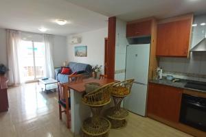 a kitchen with a table and some chairs in a room at Apartment 50m from the beach by Lofties in Pineda de Mar