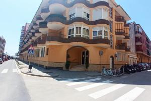 a large building on the side of a street at Apartment 50m from the beach by Lofties in Pineda de Mar