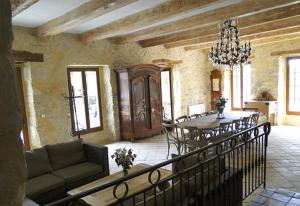 a living room with a couch and a table and chairs at Le Préau in Vallon-Pont-dʼArc